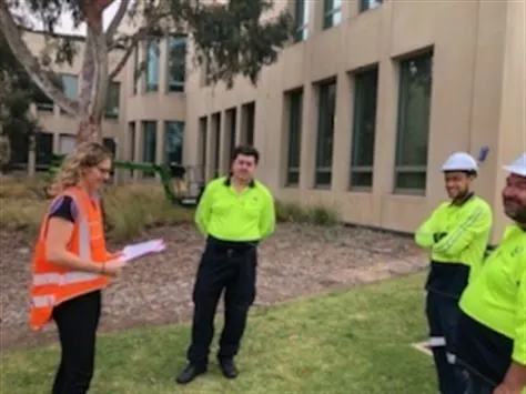 A consultant on site with workers in high-visibility clothing